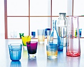 Colourful glasses, goblets and decanters on floor