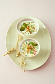 Peas and coconut soup in bowl with quinoa