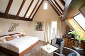 Interior of bedroom in attic of hotel, Germany