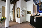 Receptionist standing at the reception counter in hotel, Germany