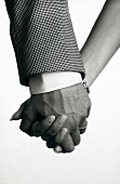 Close-up of couples hands interlocked, black and white