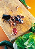 Chopped lobsters on wooden cutting board