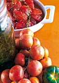 Close-up of confit and fresh tomatoes in cooking dish