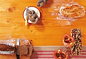 Poppy seed rolls and pretzel rolls on table, overhead view