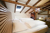 View of hotel's bedroom with wooden ceiling, Austria