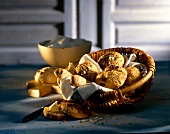 Spelled bread with raisins and potato rolls in wicker basket