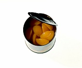 Apricots in opened jar on white background