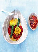 Zucchini flower with stock fish puree and tomato sauce in bowl