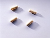 Capsules for hair care substances on white background, overhead view