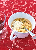 Pasta e fagioli in white cup with spoon