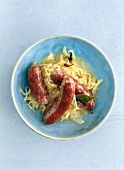 Wild duck sausage in bowl, overhead view