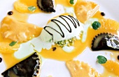 Close-up of chocolate ravioli with mint and ice cream on yellow sauce
