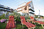 Three sun loungers in garden of Hotel Achterdiek, Juist, East Frisian Islands, Germany