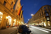 Exterior view of hotel, road and car with tail light, Germany