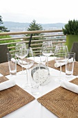 Close-up of glasses on laid table at terrace of restaurant, Switzerland