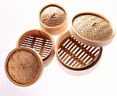 Various bamboo baskets with lids on white background