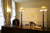 Man at reception counter in hotel, Belgium, blurred motion