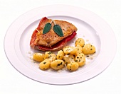 Saltimbocca with sage and gnocchi on plate