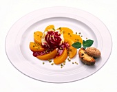 Sliced peaches with mascarpone and amaretti biscuits on plate