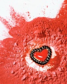 Red powder spread with a tin of heart shape on body cream