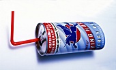 Close-up red bull can with straw on white background