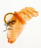 Slice of raw salmon and lemon on white background