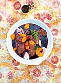 Venison with vegetables in red wine and marinade in bowl