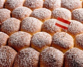 Close-up of buns with sugar icing and mini Austrian flag in it