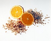 Two halves of oranges with sprouted beans on white background