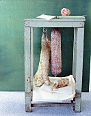 Four different types of Italian salami on stool