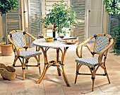 Garden terrace with rattan chairs and table