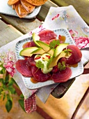 Close-up of tuna carpaccio on serving dish