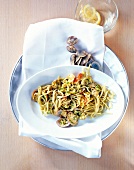 Linguine with lobster, clams and courgettes on serving dish