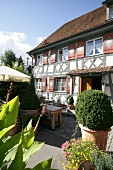 View of exterior of hotel with garden and potted plants, Germany