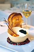 Scrambled eggs with lobster and caviar served in ostrich's egg shell