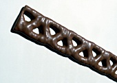 Close-up of schooling caramel braid on white background