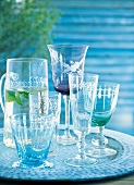 Close-up of glasses, carafe, champagne glass, water glass on metal tray