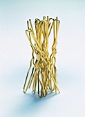 Close-up of golden hairpins arranged on white background