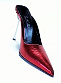 Close-up of red shiny stiletto Gucci on white background