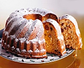 Bundt fruit pound cake with sugar icing served on plate