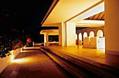 Brightly illuminated villa terraces and arcades in night, Jamaica