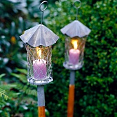 Lanterns with pink candles in garden