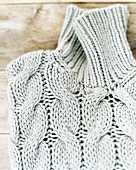 Close-up of cable knitted turtleneck sweater