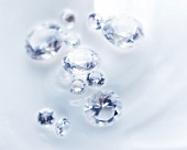 Close-up of diamonds in various size on white background