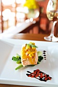 Close-up of salmon with mango sauce on plate