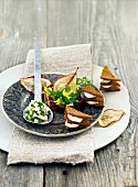 Black bread canapes with cream cheese, pears and beans