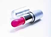 Close-up of pink lipstick on white background