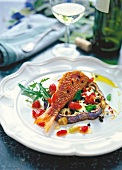 Fried red mullet with eggplant served on plate