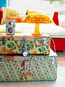 A stack of brightly patterned cases as a bedside table