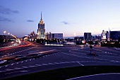 View of street and Hotel Ukraina at dusk, Moscow, Russia